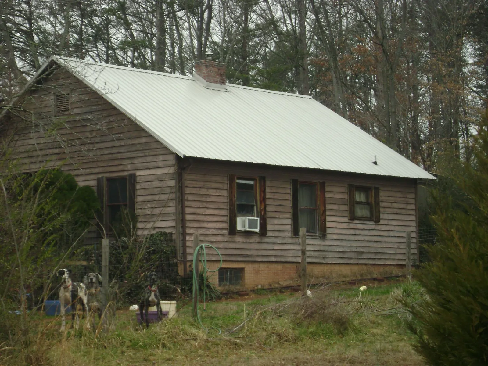 White metal roof on an old wood sided farmhouse, from a Metal Roof Installation job in Vergennes